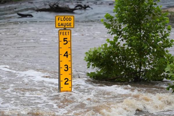 Image of flood water at a flood gauge.