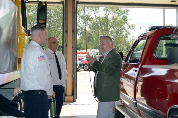 U.S. Rep. Eric Sorensen, D-Rockford (right), speaks with Rock Falls Fire Department Chief Ken Wolf III (center) and Deputy Chief Kyle Sommers on Friday, Aug. 9, 2024.
