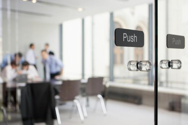 Office meeting behind glass doors