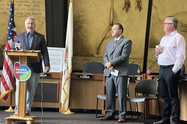 17th District Democratic Congressman Eric Sorensen (left) speaks at an event highlighting federal funding for a Peoria Heights water infrastructure project, as Director of Community Development Wayne Aldrich (middle) and mayor Mike Phelan (left) listen.