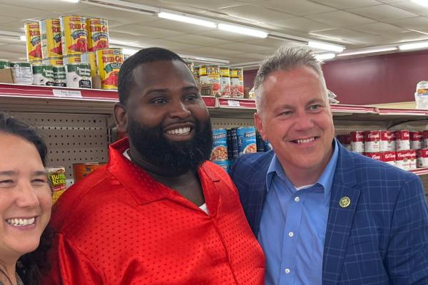 Congressman Eric Sorensen stands with grocery store owner and SBA Administrator Isabel Guzman in a grocery store, with grocery shelves behind them.