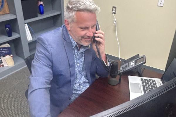 Rep. Eric Sorensen (IL-17) answers and speaks on the phone during a telephone town hall he hosted.