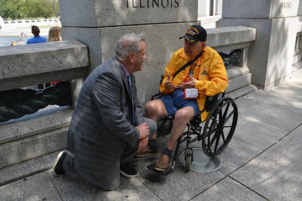 Congressman Eric Sorensen speaks to a WWII veteran at the WWII Memorial in Washington, DC