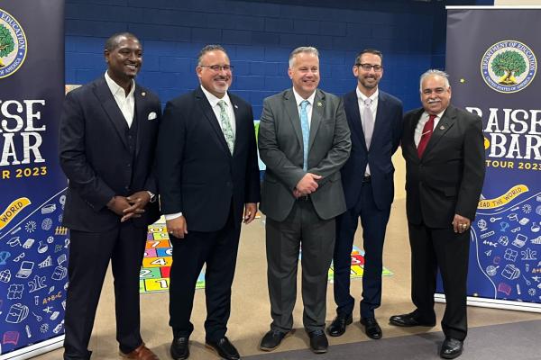Congressman Eric Sorensen and US Secretary of Education Miguel Cardona pose with local leaders at Beyer Early Childhood Center in Rockford.