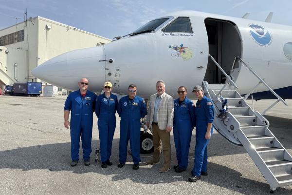 Photo of Congressman Sorensen in front of NOAA Hurricane Hunter plane with the flight crew. 