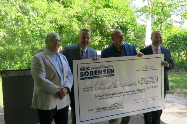 Rep Sorensen holds a check