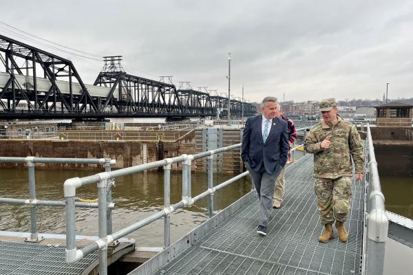 Congressman Sorensen walking with armed service member