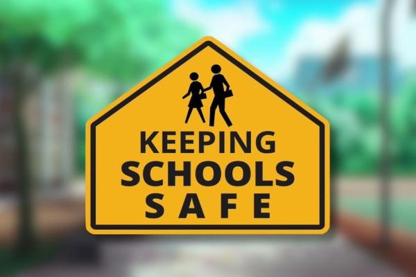 Sign reading "keeping schools safe"
