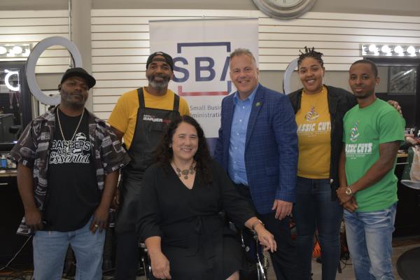 Representative Sorensen with owners of a local barber shop 