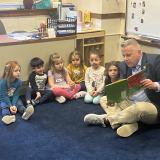 Congressman Eric Sorensen reads from a book to children in a classroom. 