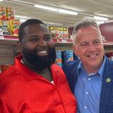 Congressman Eric Sorensen stands with grocery store owner and SBA Administrator Isabel Guzman in a grocery store, with grocery shelves behind them.