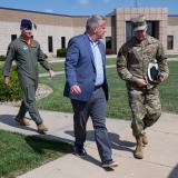 Representative Sorensen walking with two service members