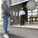 Photo of Congressman Sorensen watching a weather balloon launch. 