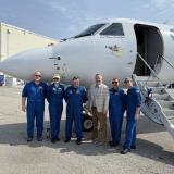 Photo of Congressman Sorensen in front of NOAA Hurricane Hunter plane with the flight crew. 