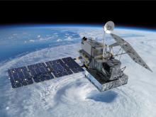 Image of a weather satellite in space over a hurricane on Earth